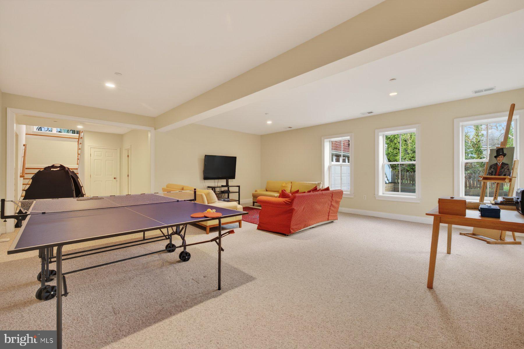 6115 Madawaska Road Bethesda, MD 20816 - Photo 57 of 78 a living room with furniture a flat screen tv and a large window