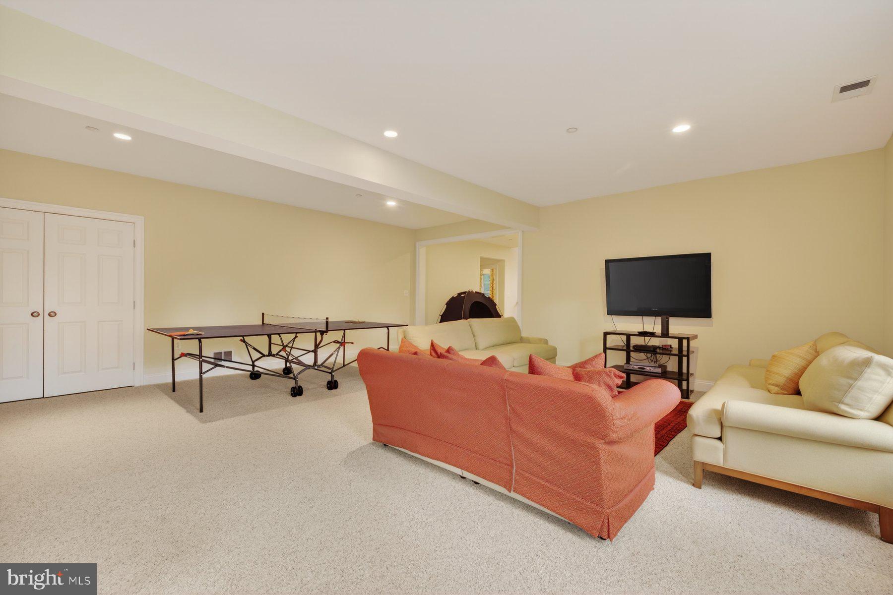 6115 Madawaska Road Bethesda, MD 20816 - Photo 58 of 78 a living room with furniture and a flat screen tv