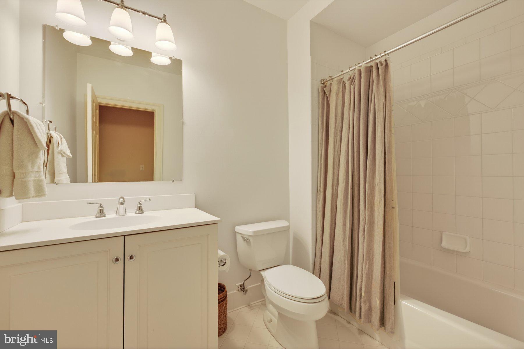 6115 Madawaska Road Bethesda, MD 20816 - Photo 60 of 78 a bathroom with a toilet a sink and a mirror