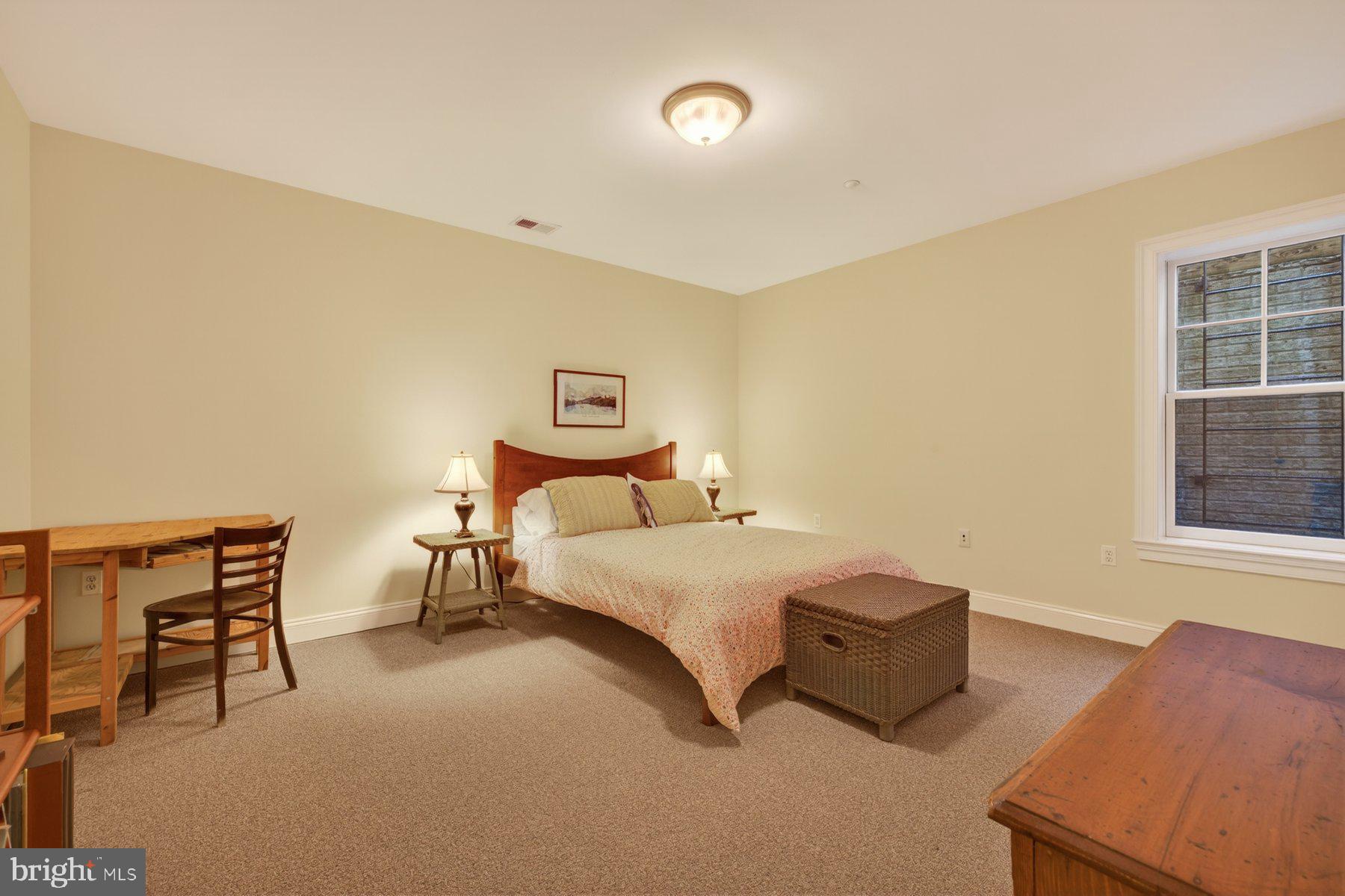 6115 Madawaska Road Bethesda, MD 20816 - Photo 61 of 78 a spacious bedroom with a bed and a window