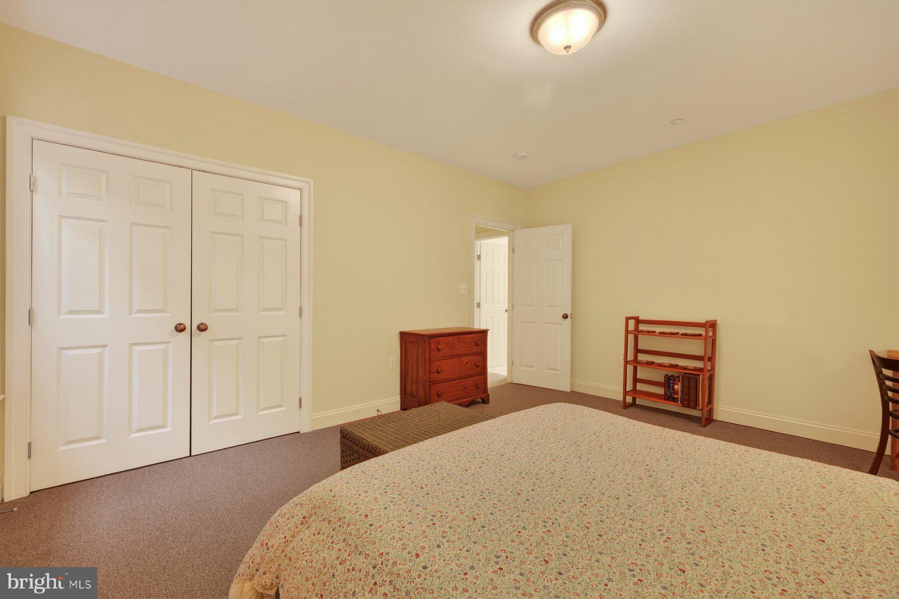 6115 Madawaska Road Bethesda, MD 20816 - Photo 62 of 78 a bedroom with a bed and a lamp