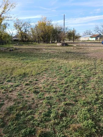 a view of a field with an ocean