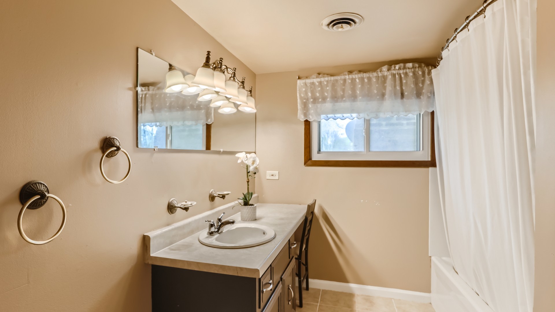 7809 45th Street Lyons, IL 60534 - Photo 11 of 19 a bathroom with a sink and a mirror