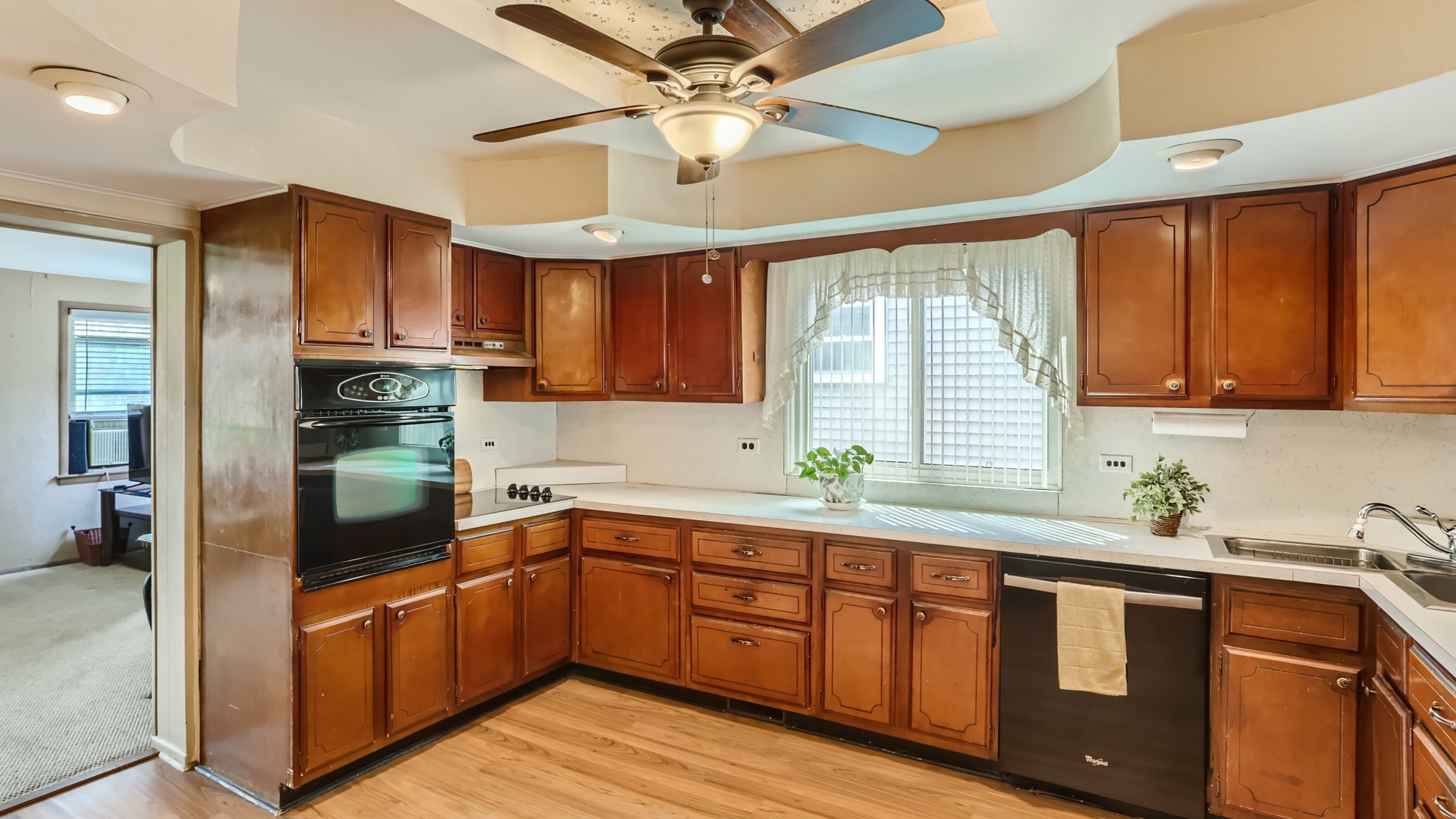 7809 45th Street Lyons, IL 60534 - Photo 6 of 19 a kitchen with stainless steel appliances granite countertop a refrigerator a sink dishwasher a stove and white countertops with wooden floor