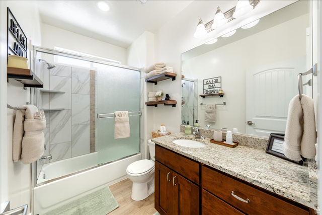 357 East Main Street Enterprise, UT 84725 - Photo 51 of 71 Full bathroom with vanity, bath / shower combo with glass door, and light wood finished floors
