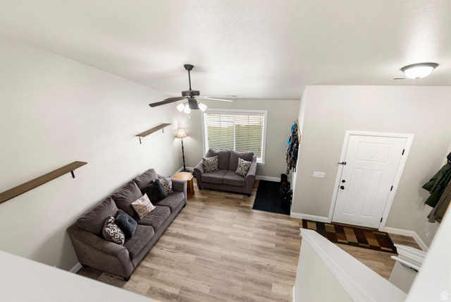 2485 South 1100th Street West Logan, UT 84321 - Photo 13 of 53 Open-concept living area featuring wood-finish flooring, a ceiling fan with integrated lighting, and high ceilings