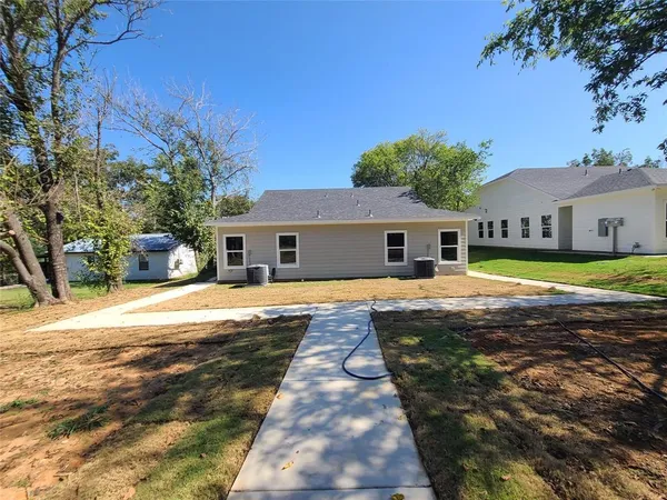 a front view of a house with swimming pool and a yard