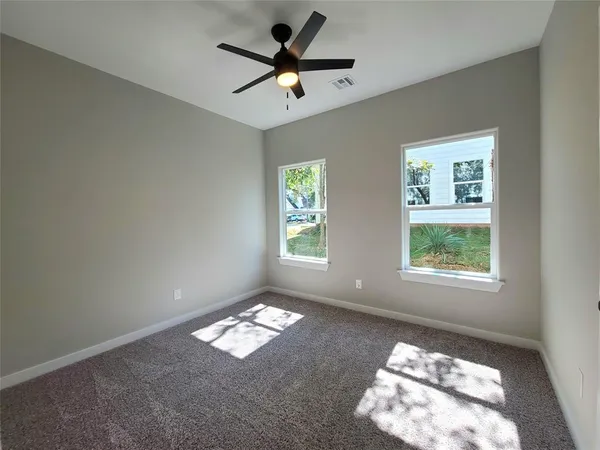 a bedroom with bed and a window