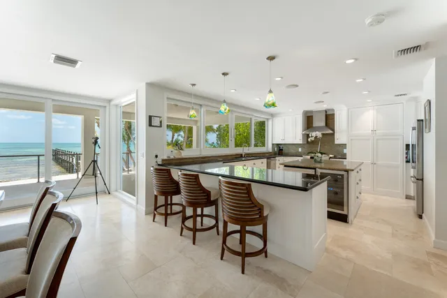 a living room with furniture a flat screen tv and a large window