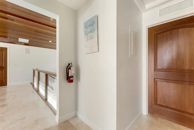 a front view of a building with a garden and plants