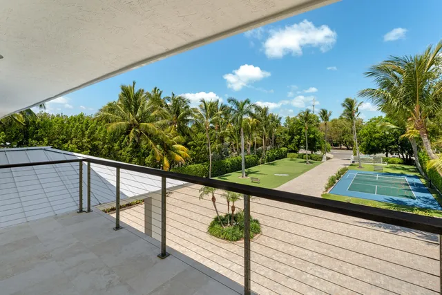 aerial view of a house with a yard and lake view