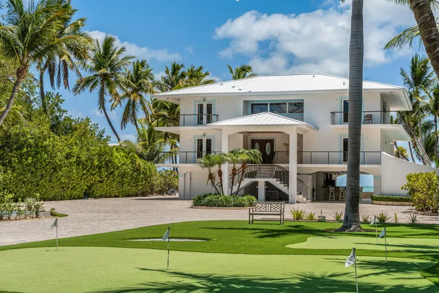a dining room with furniture a chandelier and wooden floor