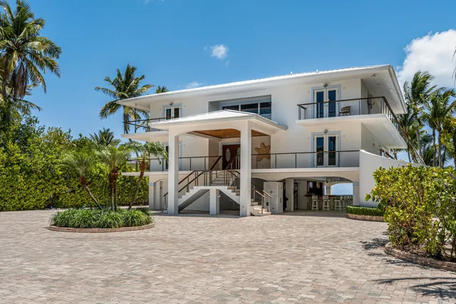 a dining room with furniture and a view of kitchen