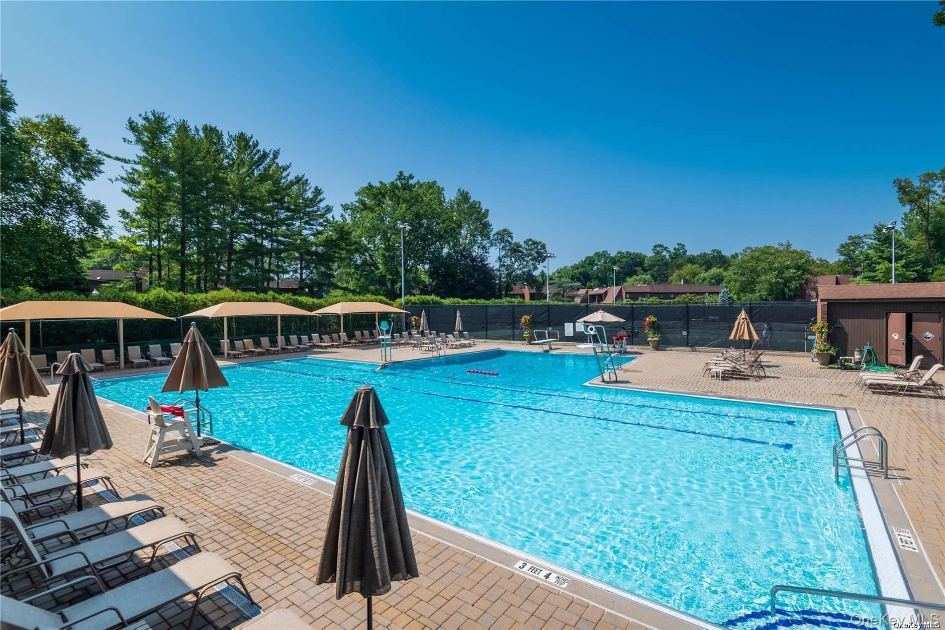 15 Spring Hollow Road Roslyn, NY 11576 - Photo 26 of 30 a view of a swimming pool with a patio and a garden