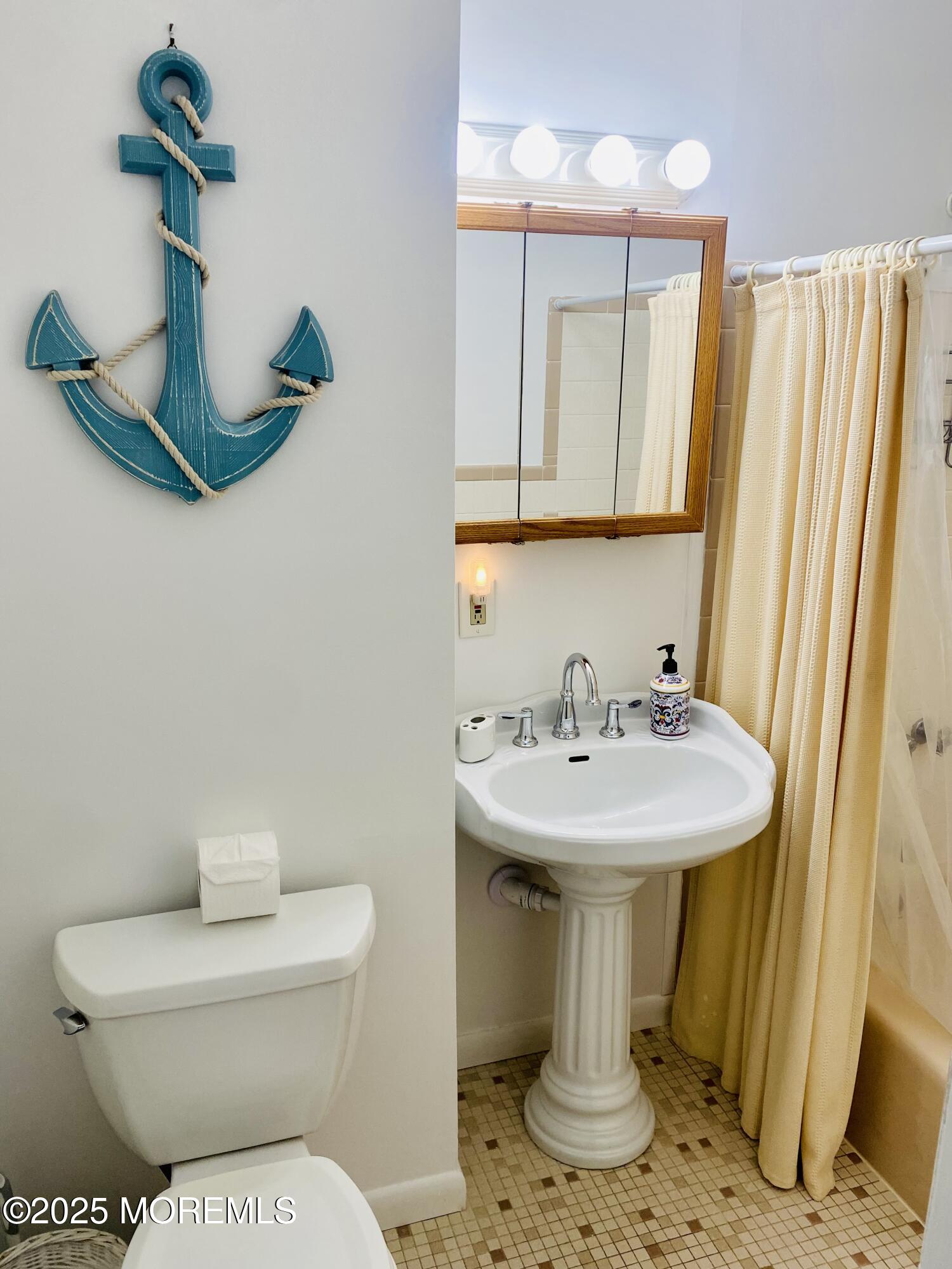 4 Camden Avenue, Unit WINTER Lavallette, NJ 08735 - Photo 12 of 13 a bathroom with a toilet sink and mirror