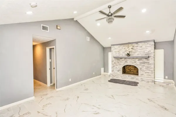 a spacious bathroom with a granite countertop sink a mirror and shower
