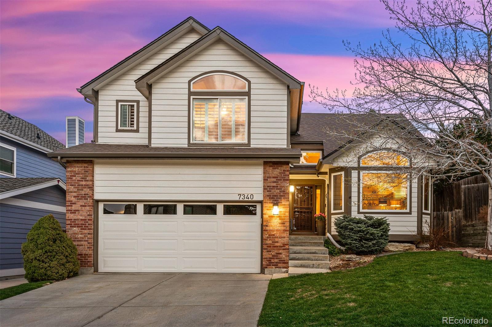 a front view of a house with a yard
