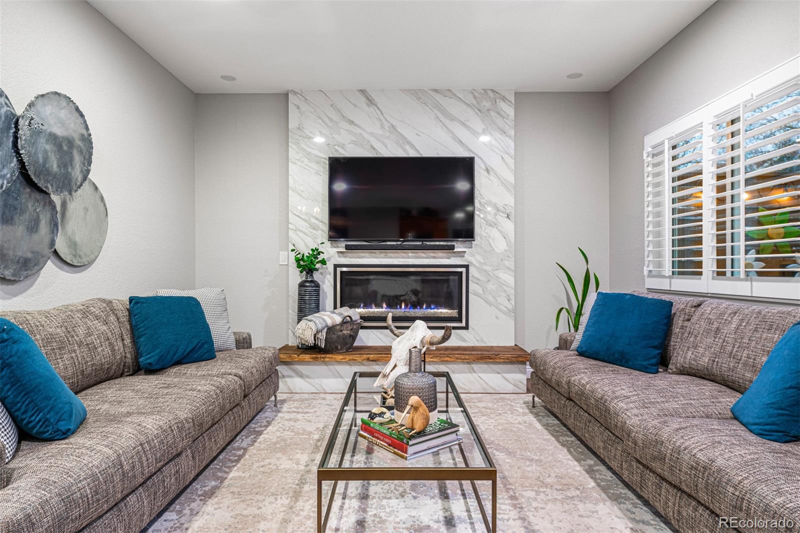 7340 Rattlesnake Drive Lone Tree, CO 80124 - Photo 14 of 33 a living room with furniture fireplace and a flat screen tv