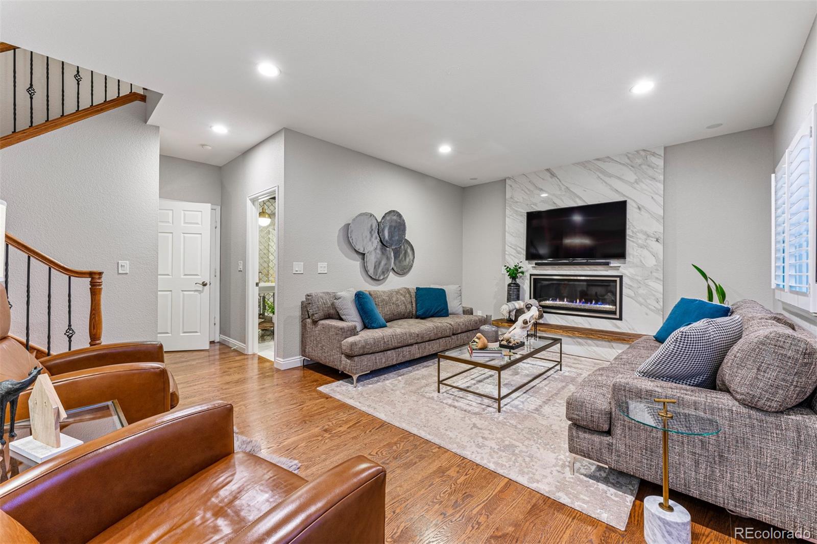 7340 Rattlesnake Drive Lone Tree, CO 80124 - Photo 15 of 33 a living room with furniture and a flat screen tv