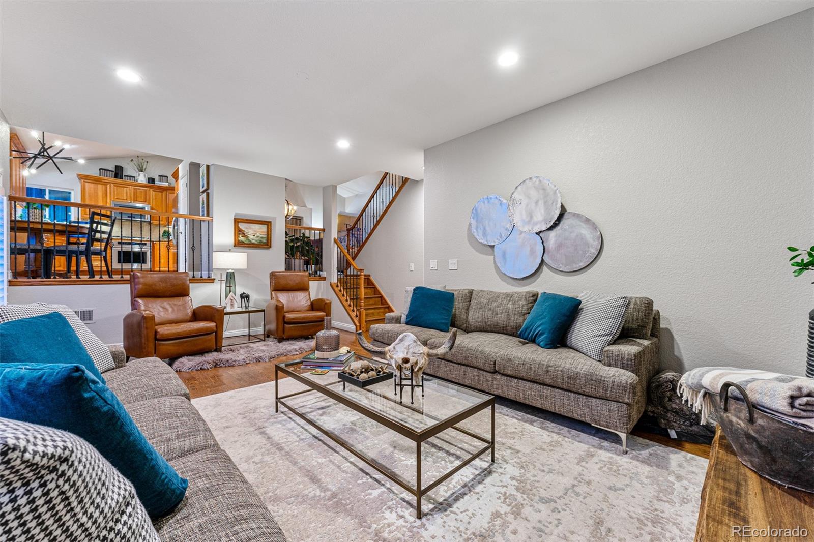 7340 Rattlesnake Drive Lone Tree, CO 80124 - Photo 16 of 33 a living room with furniture kitchen view and a rug