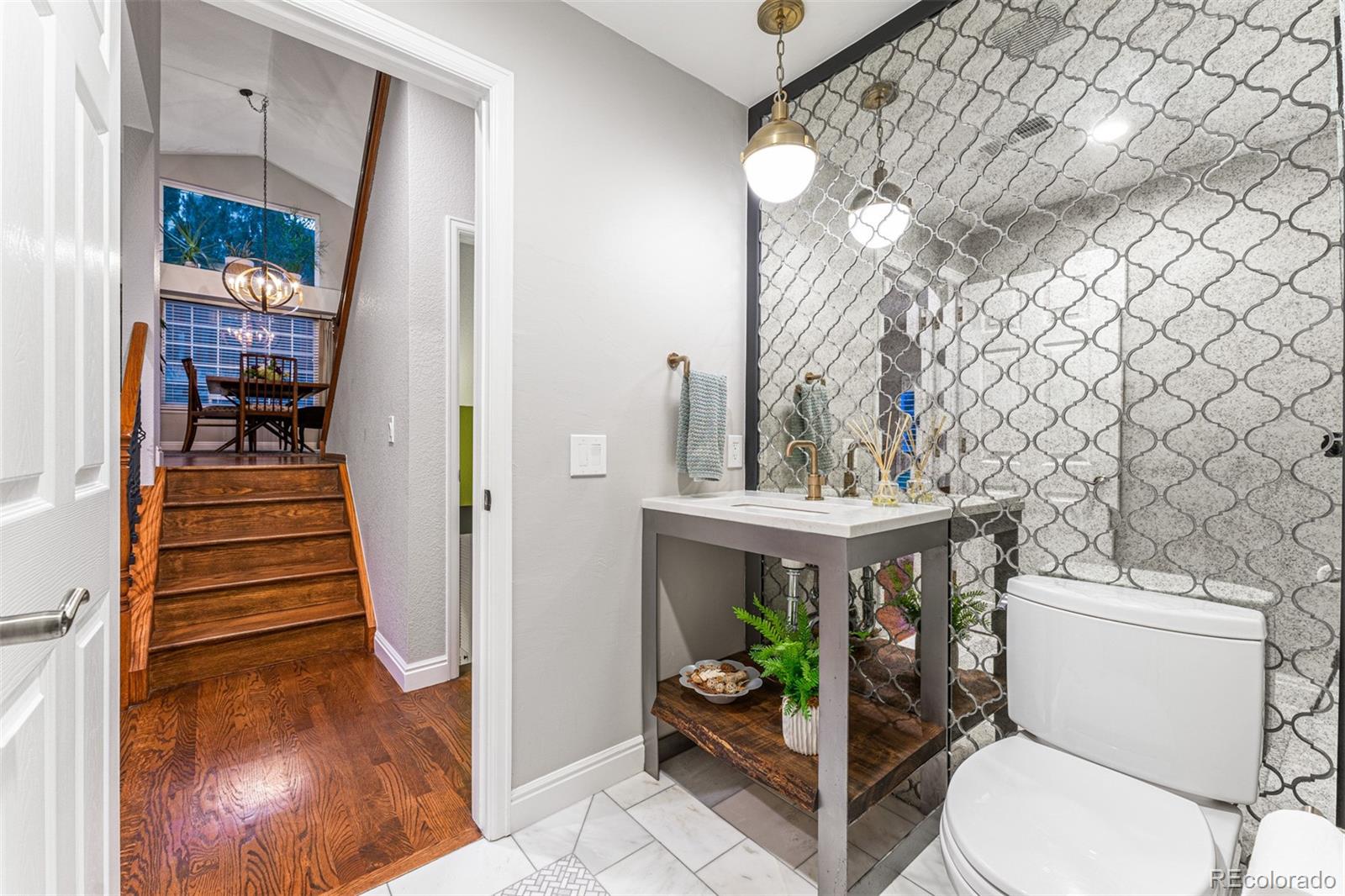 7340 Rattlesnake Drive Lone Tree, CO 80124 - Photo 18 of 33 a bathroom with a toilet sink and mirror