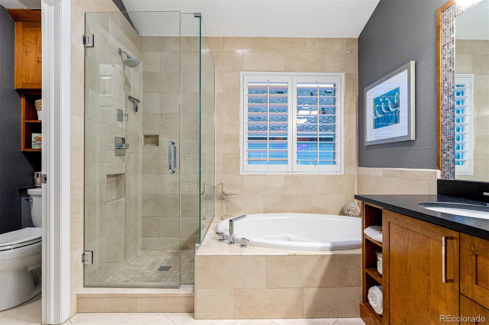7340 Rattlesnake Drive Lone Tree, CO 80124 - Photo 22 of 33 a bathroom with a bathtub and a shower