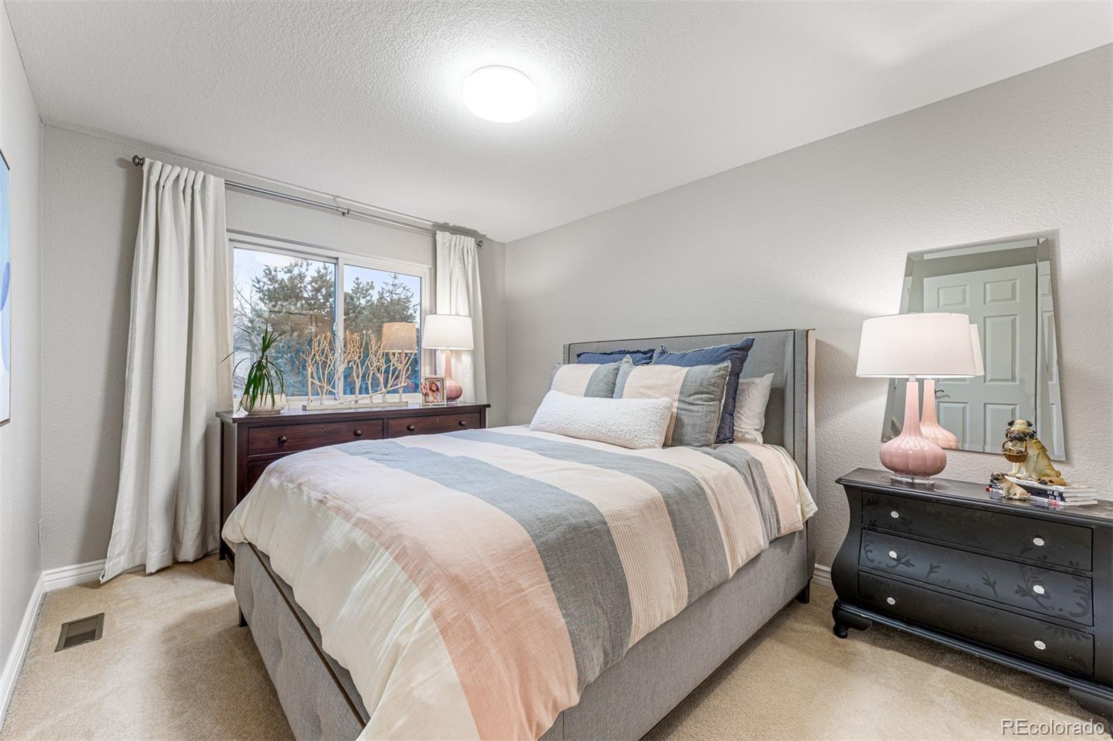 7340 Rattlesnake Drive Lone Tree, CO 80124 - Photo 23 of 33 a bedroom with a bed and a window