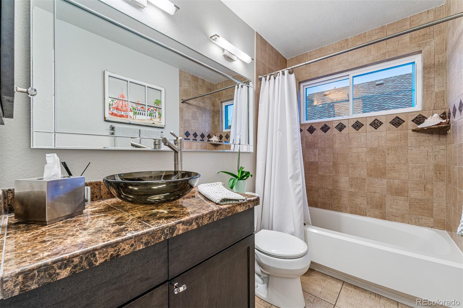 7340 Rattlesnake Drive Lone Tree, CO 80124 - Photo 25 of 33 a bathroom with a granite countertop sink toilet and shower