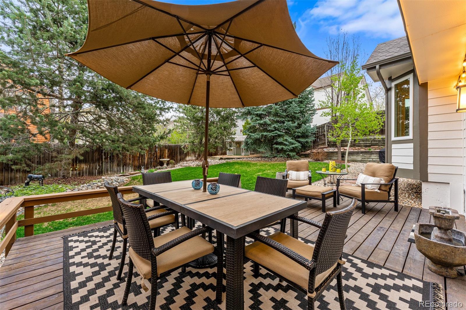 7340 Rattlesnake Drive Lone Tree, CO 80124 - Photo 31 of 33 a view of a patio with a table and chairs under an umbrella
