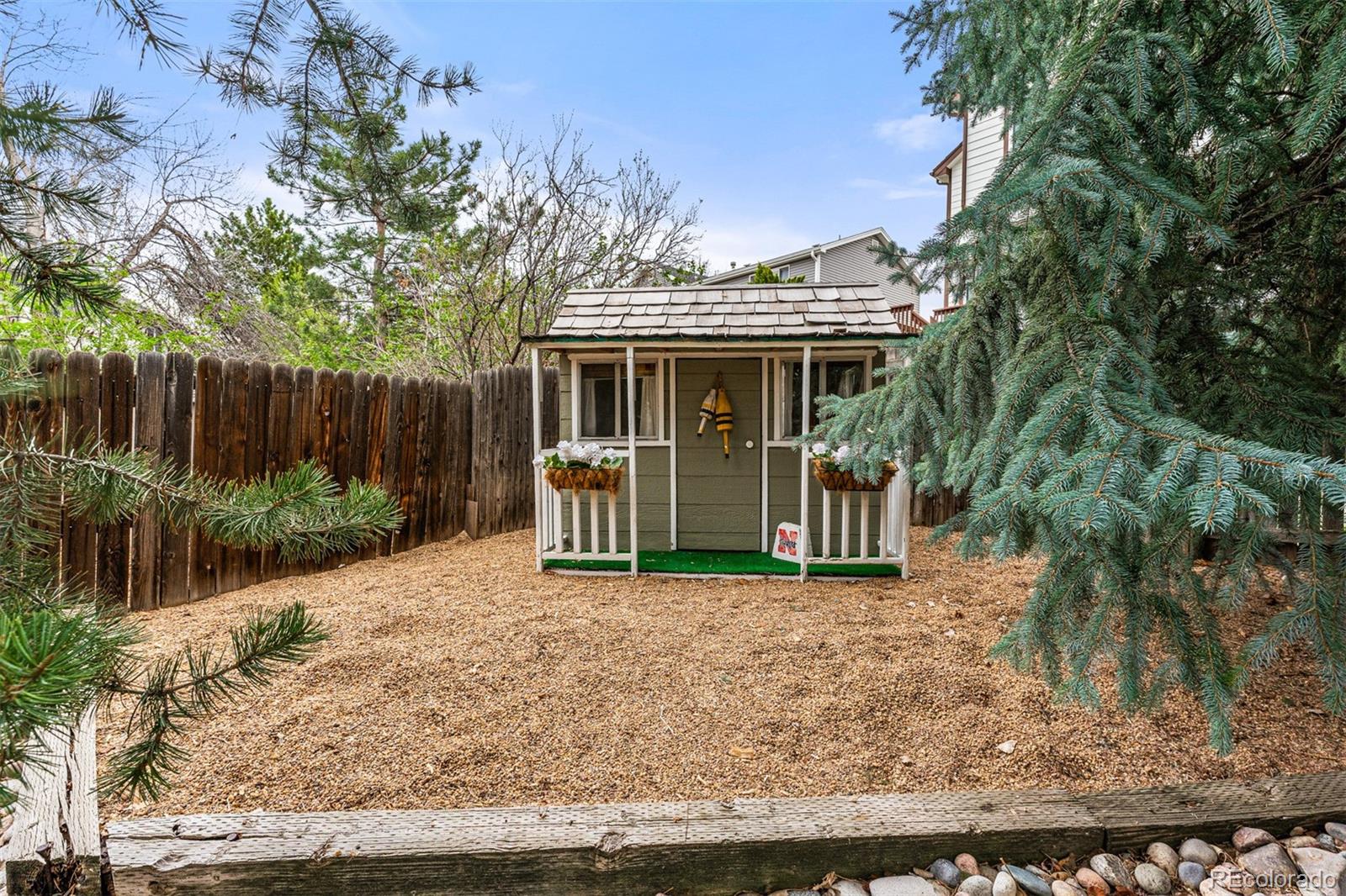 7340 Rattlesnake Drive Lone Tree, CO 80124 - Photo 32 of 33 a view of house with a yard and potted plants