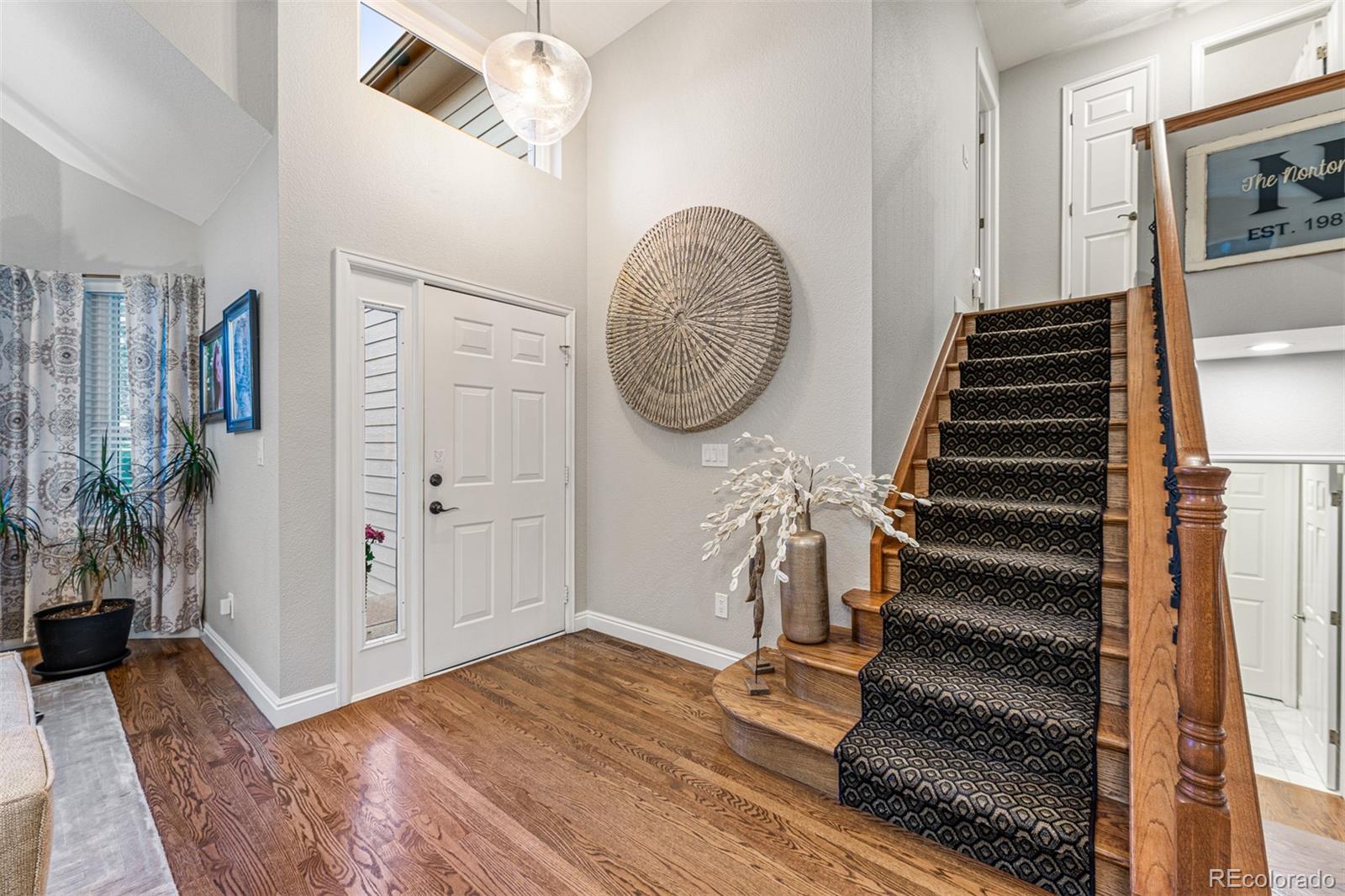 7340 Rattlesnake Drive Lone Tree, CO 80124 - Photo 4 of 33 a view of entryway with wooden floor
