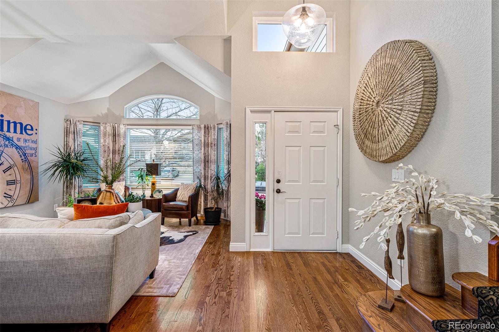7340 Rattlesnake Drive Lone Tree, CO 80124 - Photo 5 of 33 a living room with furniture large window and wooden floor