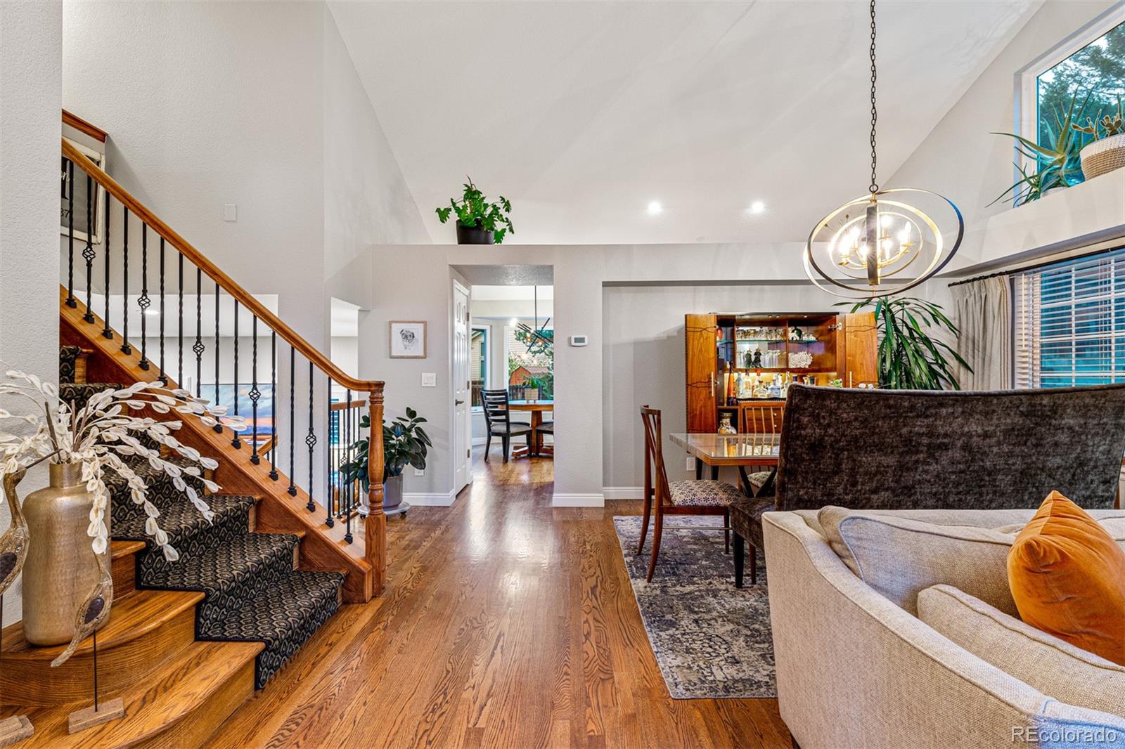 7340 Rattlesnake Drive Lone Tree, CO 80124 - Photo 6 of 33 a living room with couches chandelier furniture and a large window