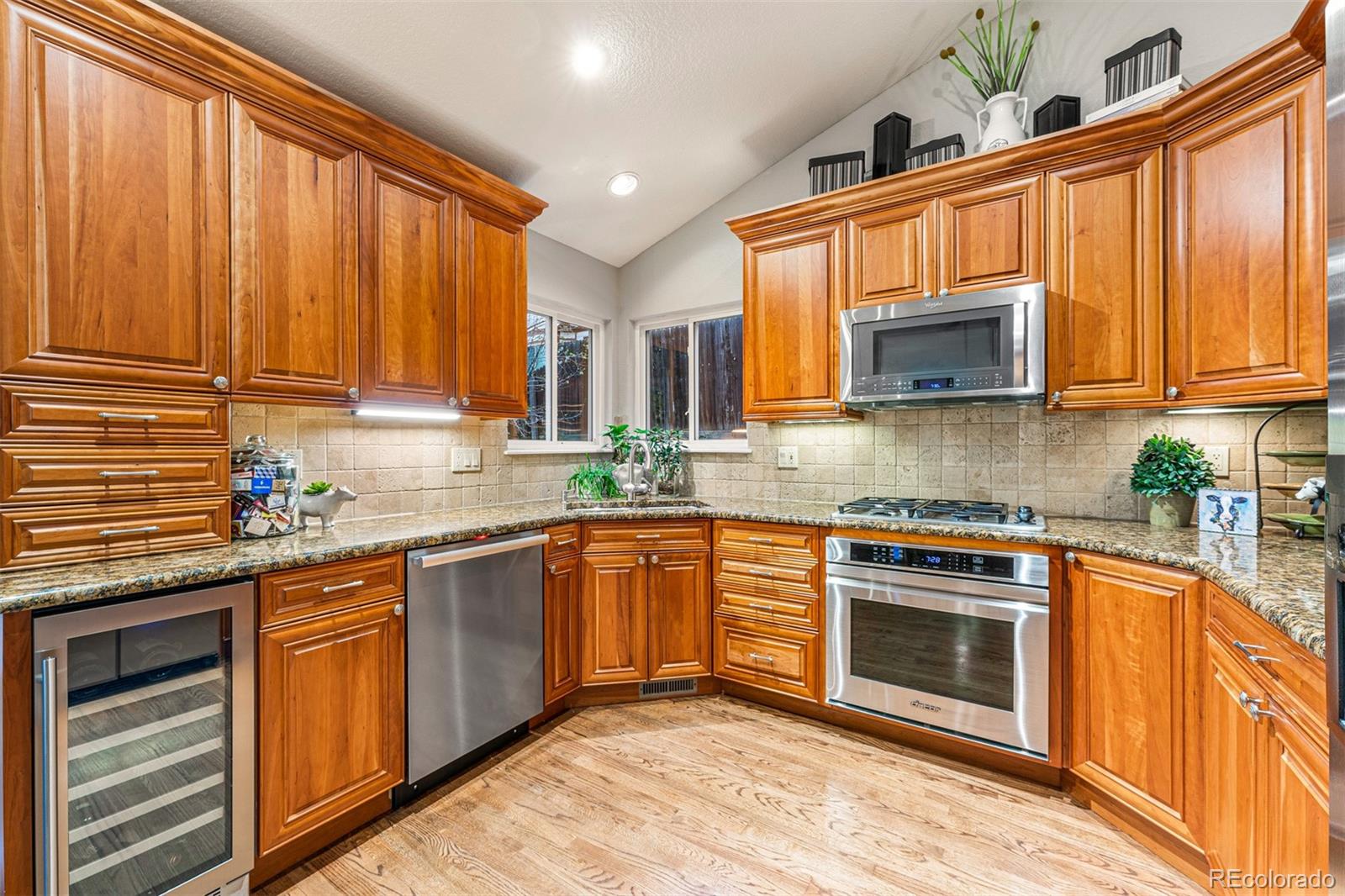 7340 Rattlesnake Drive Lone Tree, CO 80124 - Photo 9 of 33 a kitchen with stainless steel appliances granite countertop a stove microwave and sink