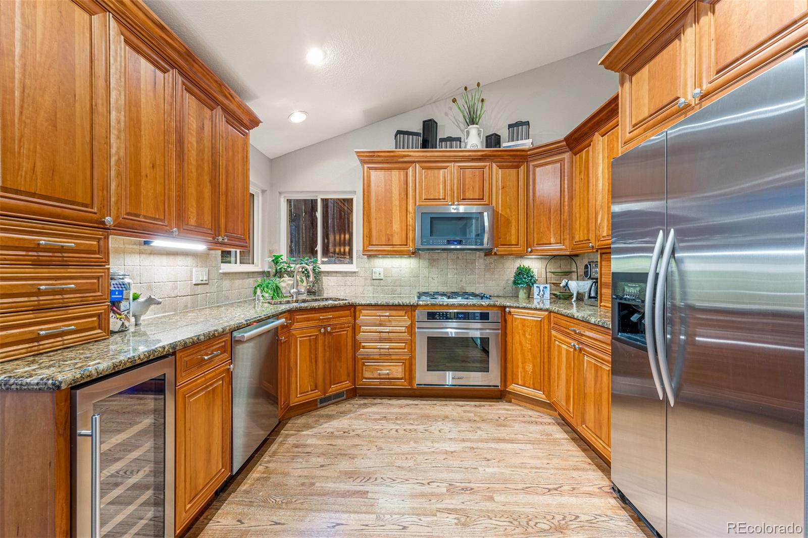 7340 Rattlesnake Drive Lone Tree, CO 80124 - Photo 10 of 33 a kitchen with stainless steel appliances granite countertop a sink and cabinets