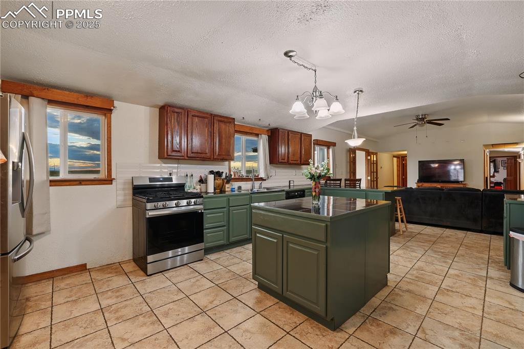 6615 Mulberry Road Calhan, CO 80808 - Photo 13 of 50 a kitchen with stainless steel appliances granite countertop a stove top oven a sink dishwasher and a refrigerator