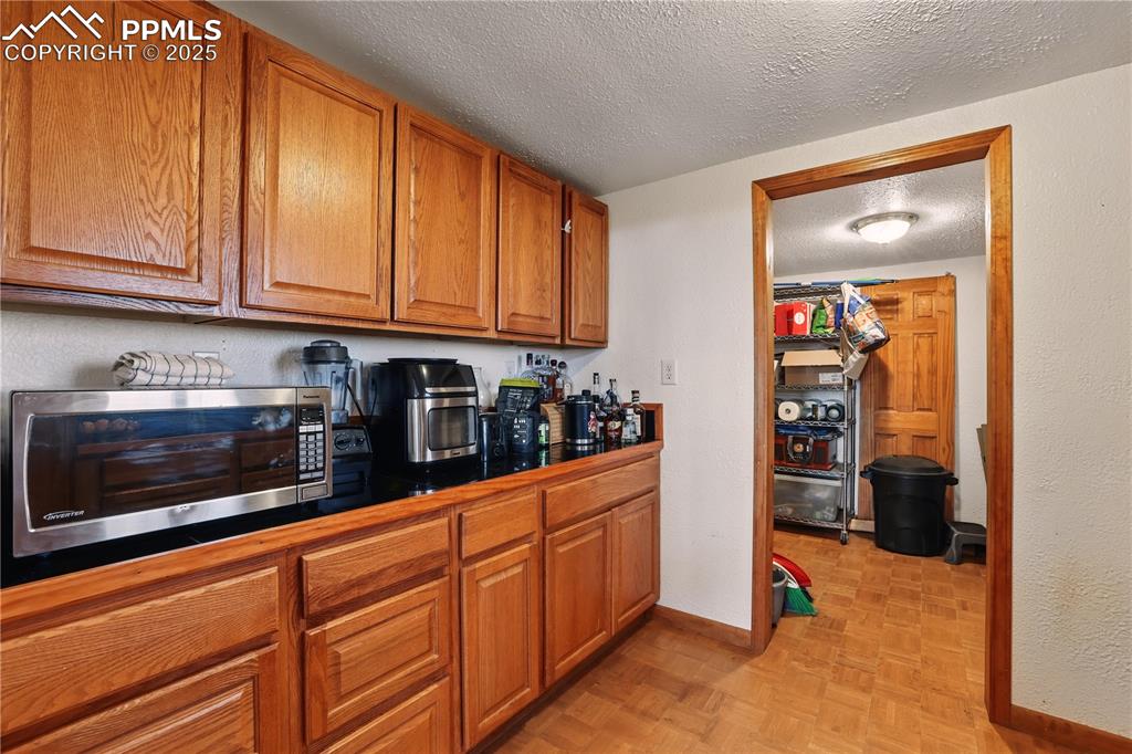 6615 Mulberry Road Calhan, CO 80808 - Photo 16 of 50 a kitchen with stainless steel appliances granite countertop a refrigerator and a stove top oven