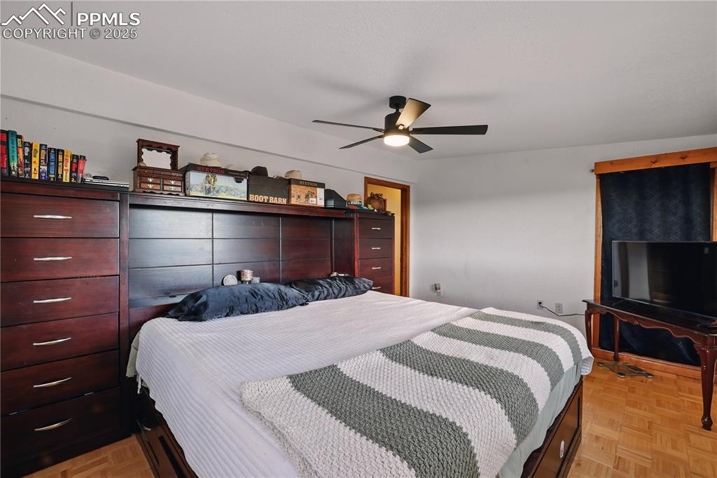 6615 Mulberry Road Calhan, CO 80808 - Photo 25 of 50 a bedroom with a large bed and a flat screen tv