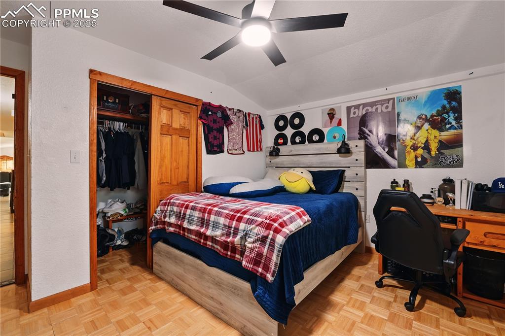 6615 Mulberry Road Calhan, CO 80808 - Photo 31 of 50 a bedroom with a bed and a chandelier