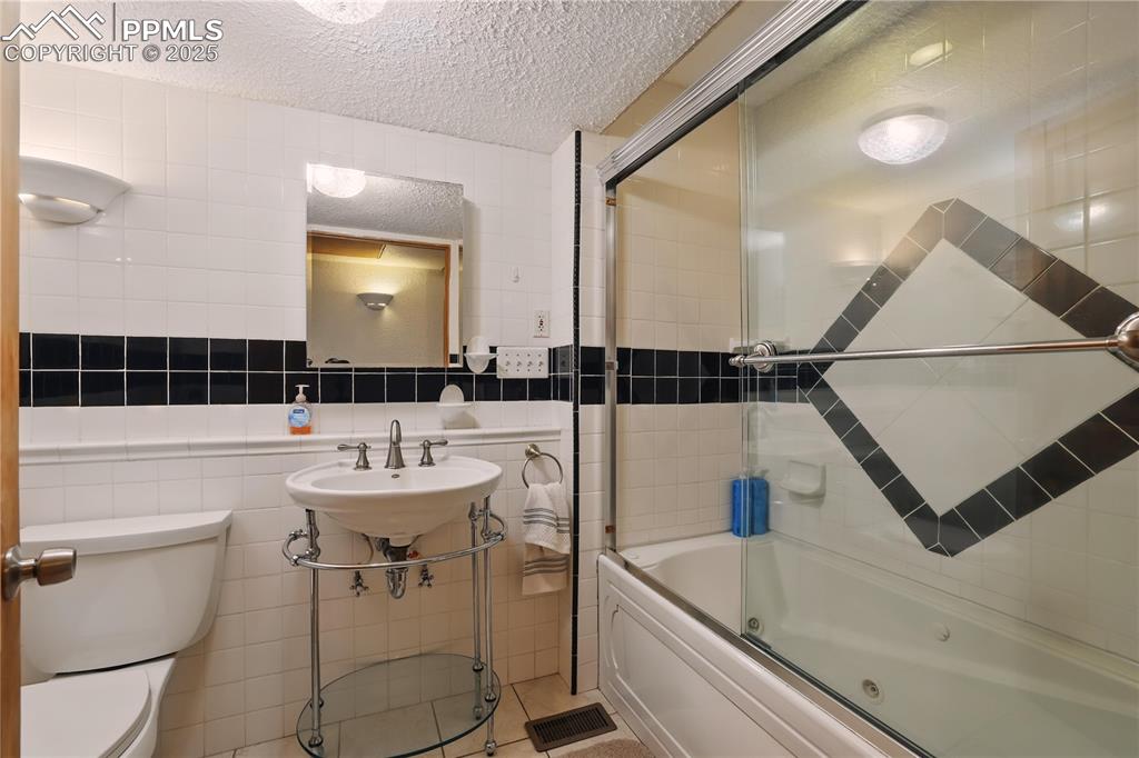 6615 Mulberry Road Calhan, CO 80808 - Photo 34 of 50 a bathroom with a sink a toilet a mirror and shower