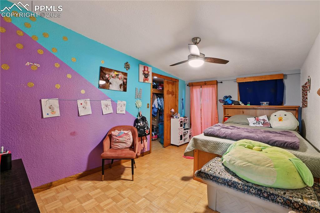 6615 Mulberry Road Calhan, CO 80808 - Photo 35 of 50 a bed room with a bed and a chandelier