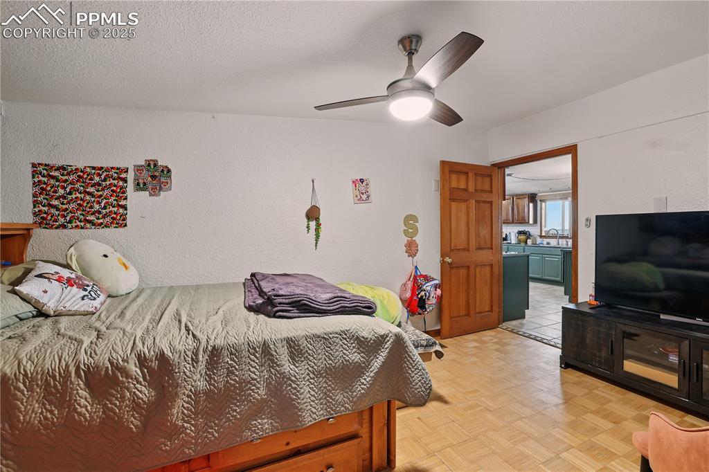 6615 Mulberry Road Calhan, CO 80808 - Photo 36 of 50 a bedroom with a bed and a flat screen tv