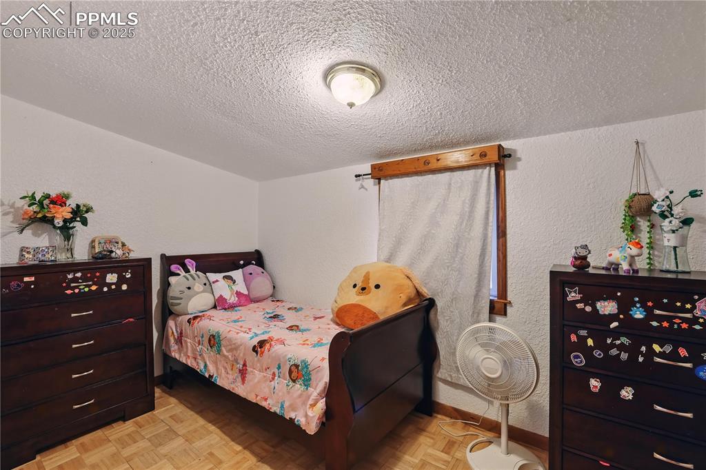 6615 Mulberry Road Calhan, CO 80808 - Photo 37 of 50 a bedroom with a bed and a dresser