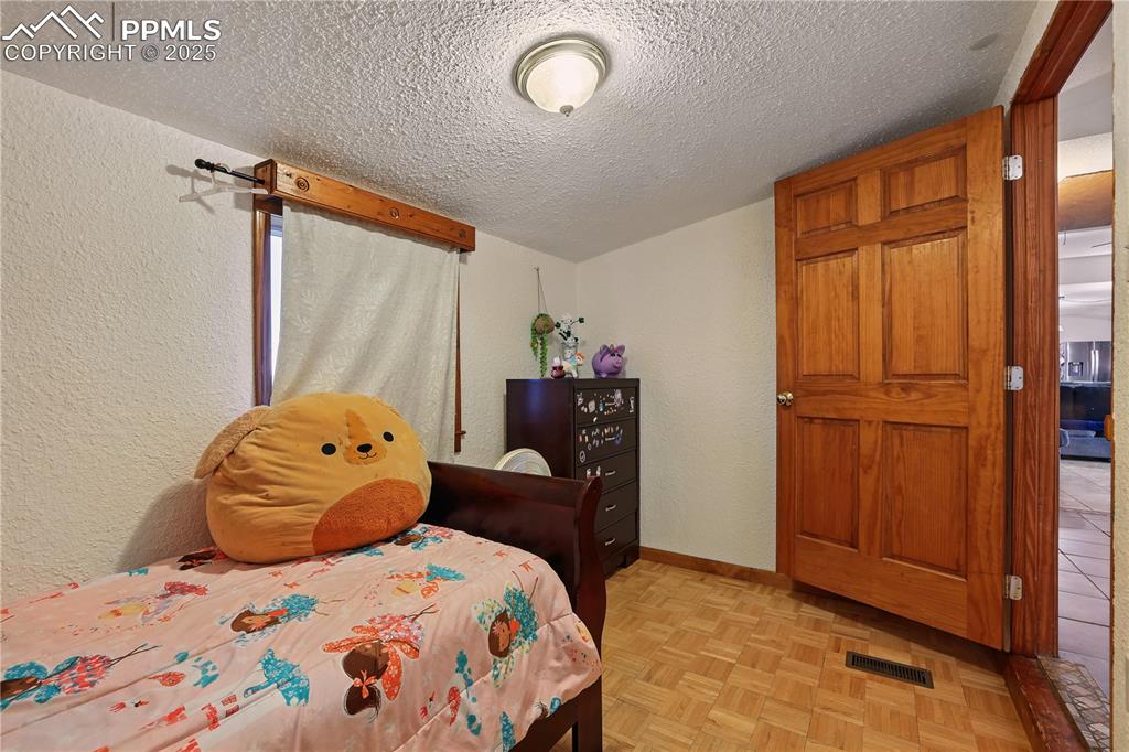 6615 Mulberry Road Calhan, CO 80808 - Photo 38 of 50 a bedroom with a bed and wooden floor