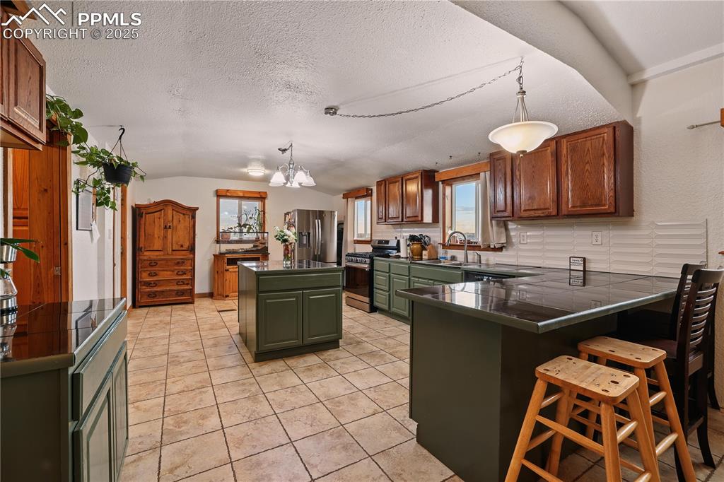 6615 Mulberry Road Calhan, CO 80808 - Photo 7 of 50 a kitchen with stainless steel appliances granite countertop a sink a stove counter space and cabinets