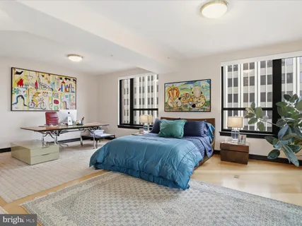 a bedroom with a bed couch and a window