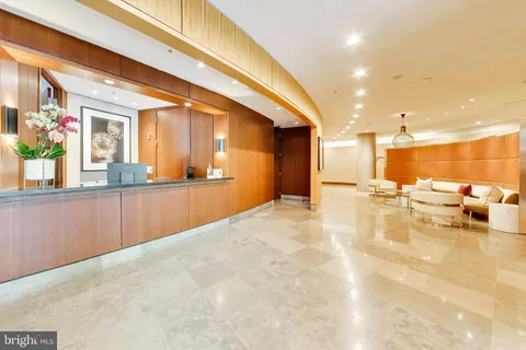 a view of a kitchen with a sink and living room view