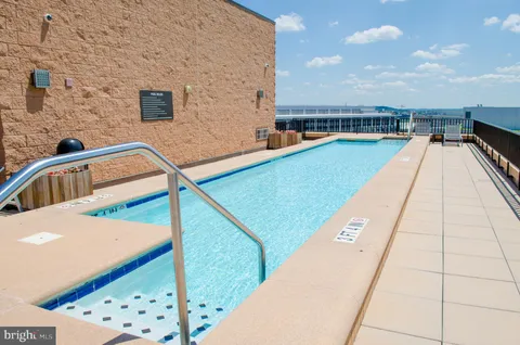 a view of swimming pool with seating space