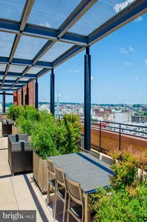 a view of a chairs and table in the balcony