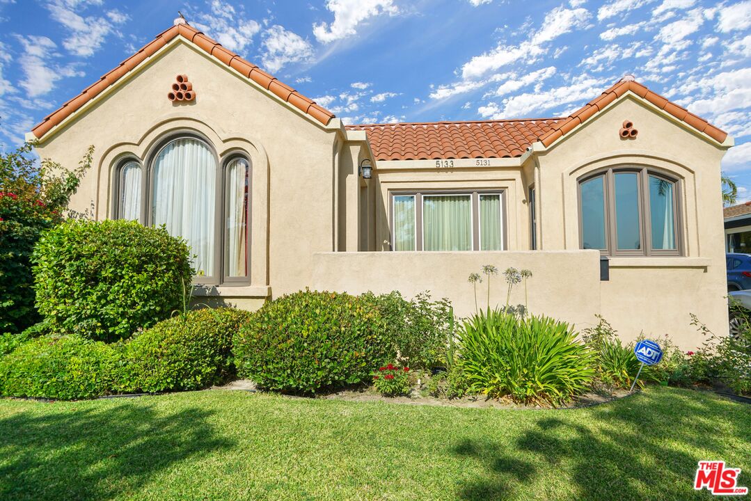 a view of a house with a small yard